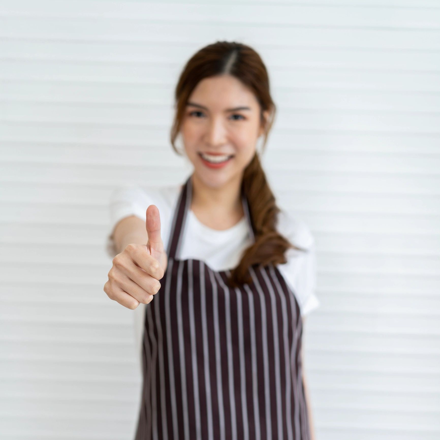 Portrait of a team member giving a thumbs up