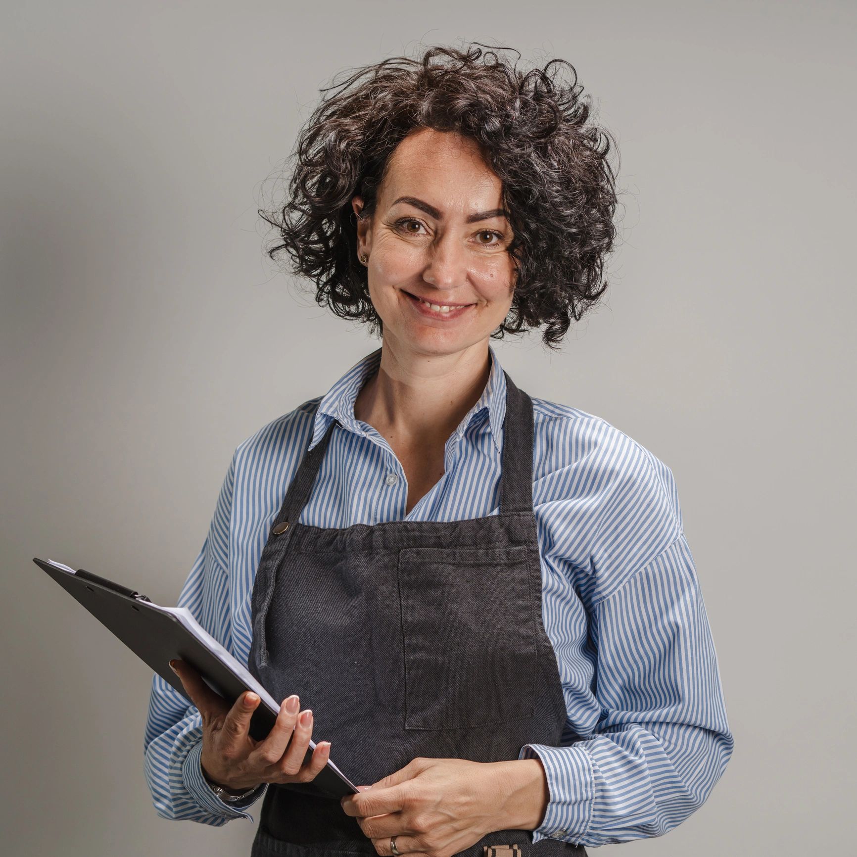 Portrait of a friendly team member holding a clipboard